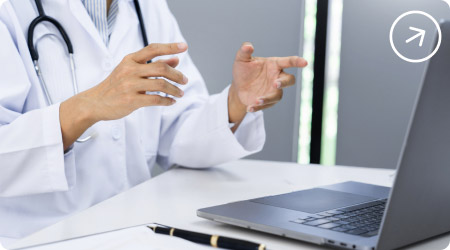 Médico especialista realizando una consulta de telemedicina a través de su computador portátil.